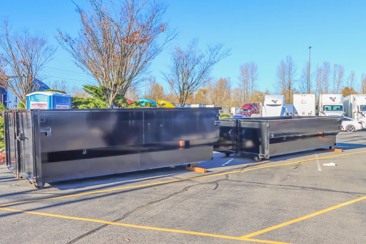 Professional dumpster rental service with roll-off container on residential driveway in Stickney